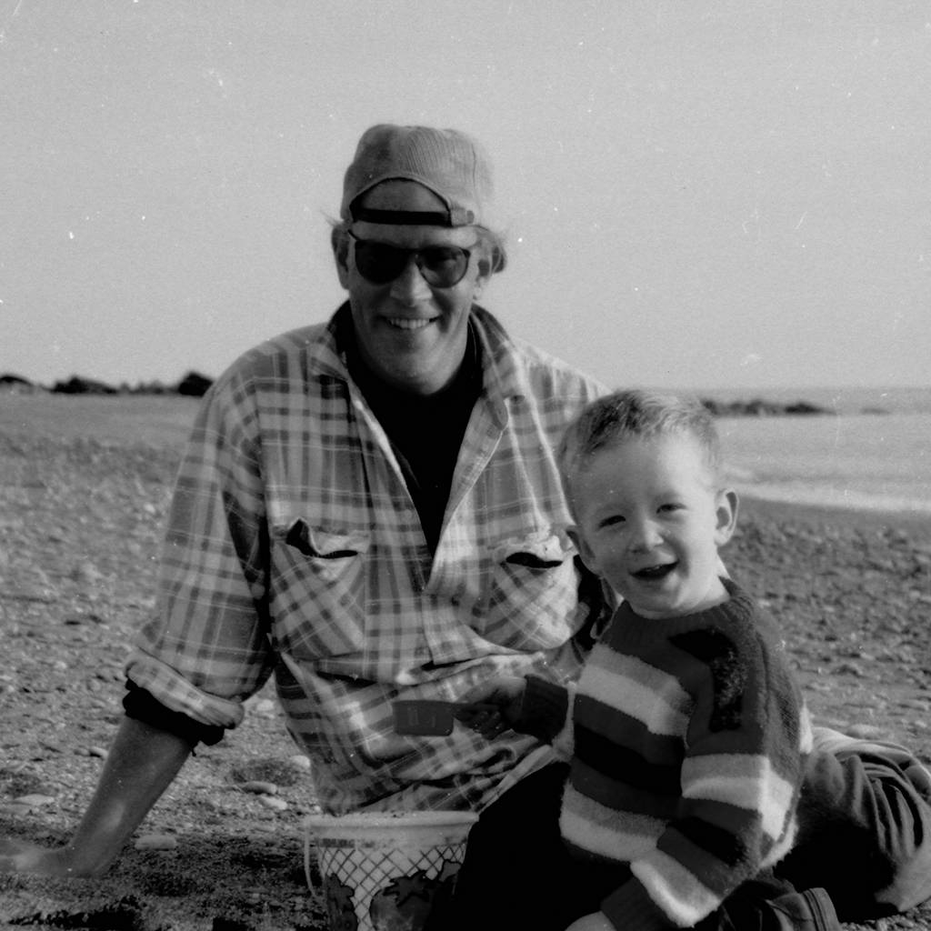 Photo of young Finn on the beach with his dad