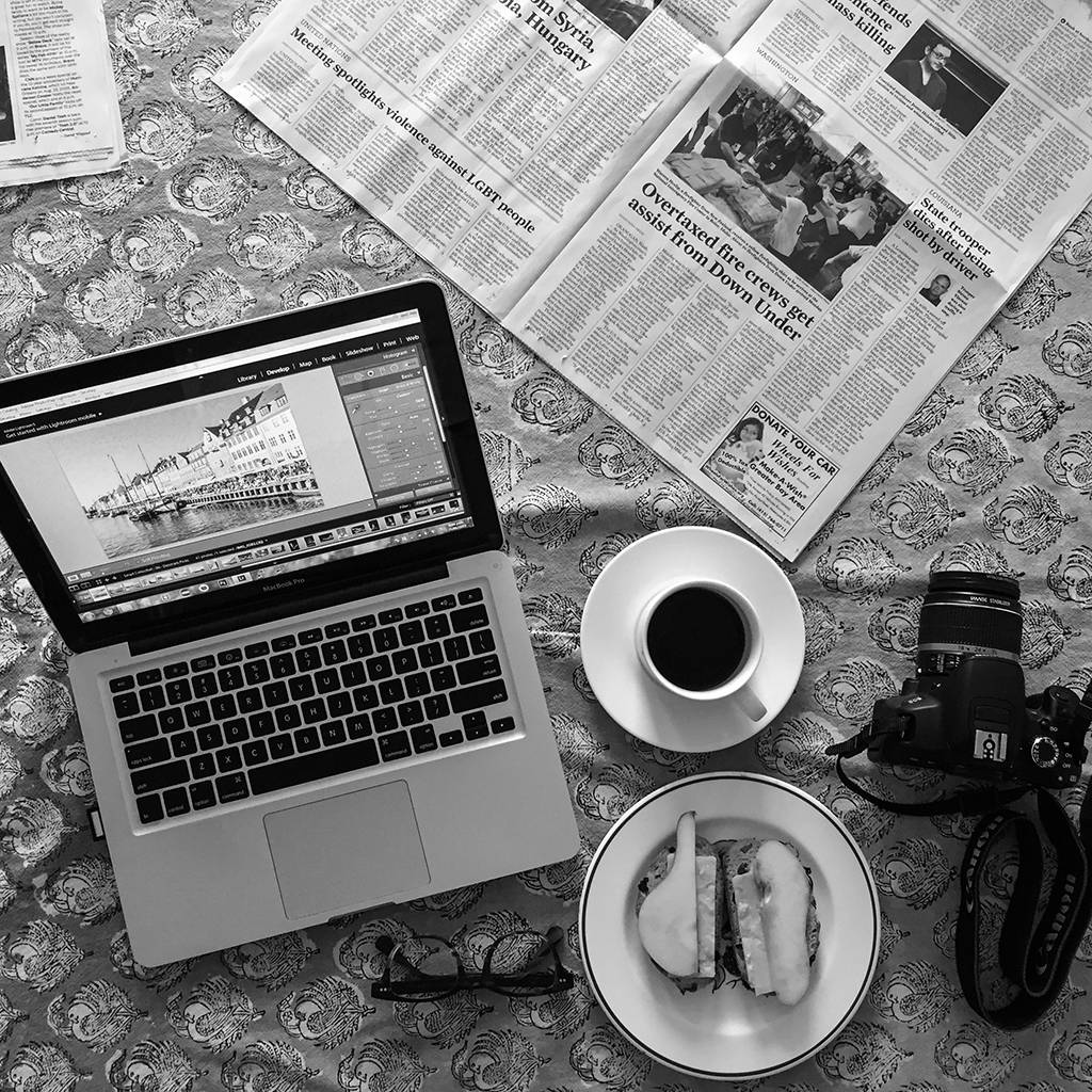 Photo of a Macbook and DSLR camera on a table